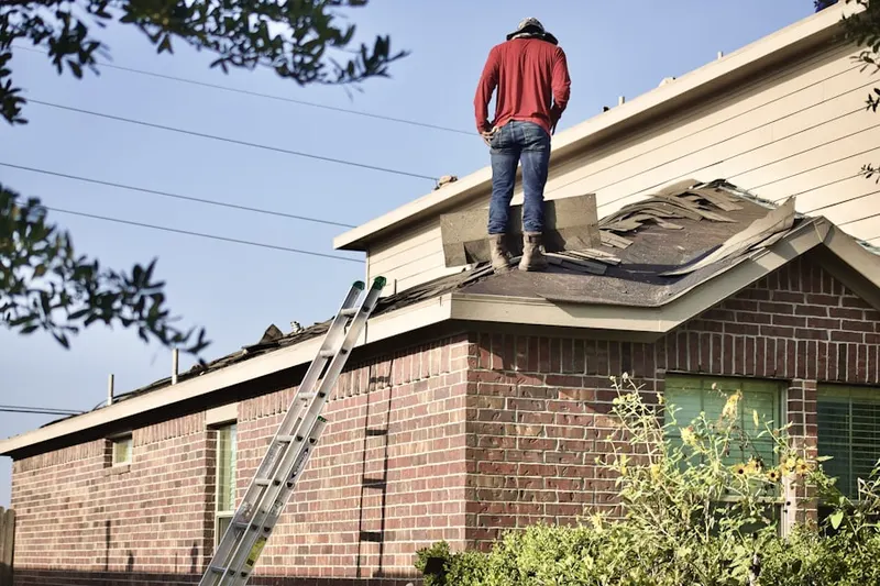 Professional roofer working on a residential roof in Fort Whipple